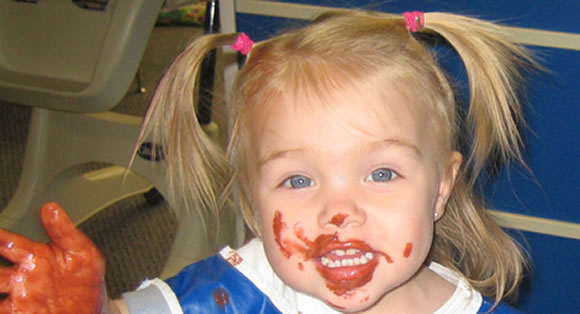 Picture of girl with paint on her face and link to Homepage